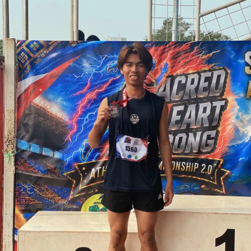 Cyberjaya College Kota Kinabalu student-athlete holding a medal at the Sacred Heart Inobong Athletic Championship 2.0